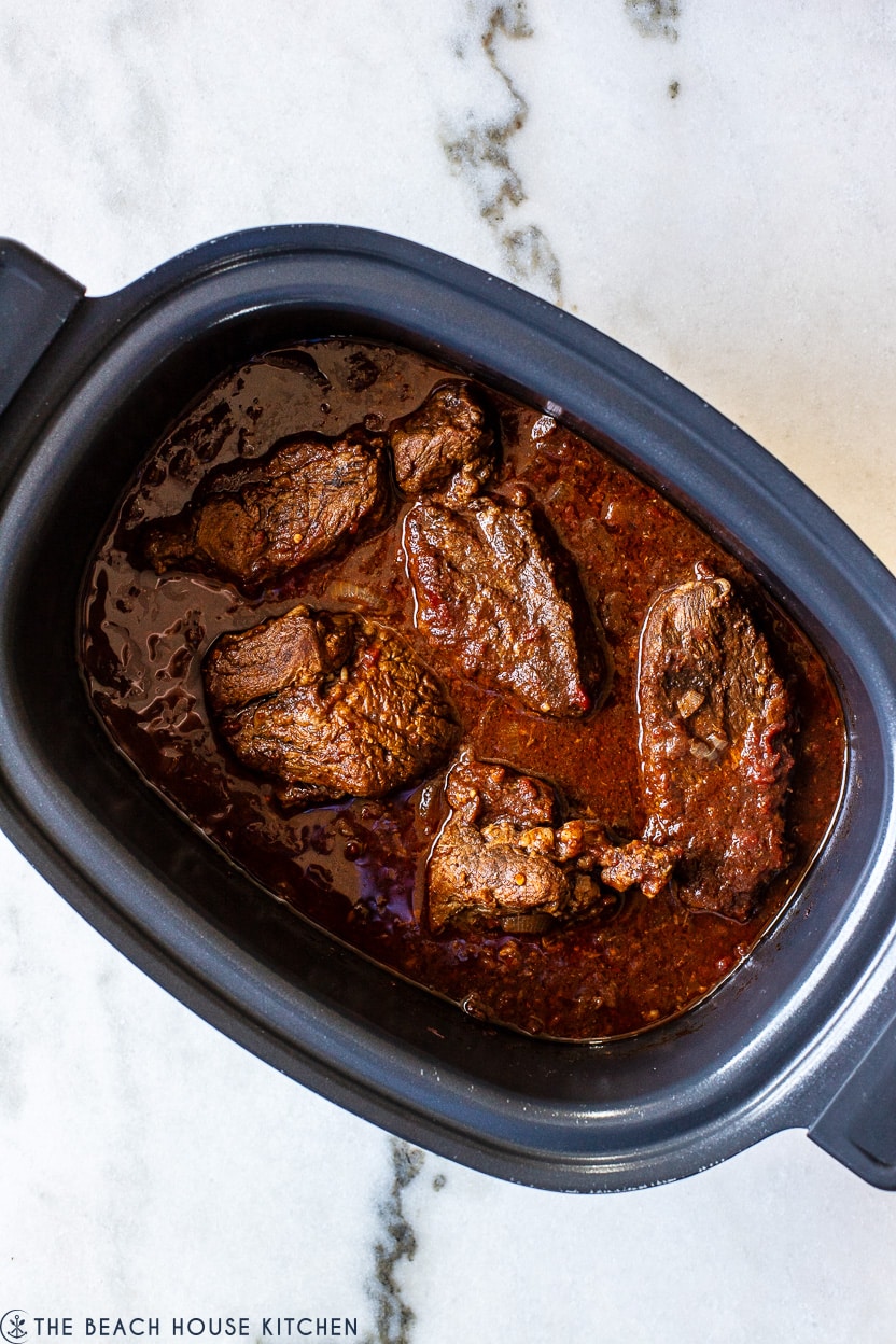 Overhead photo of a slow cooker of beef tinga