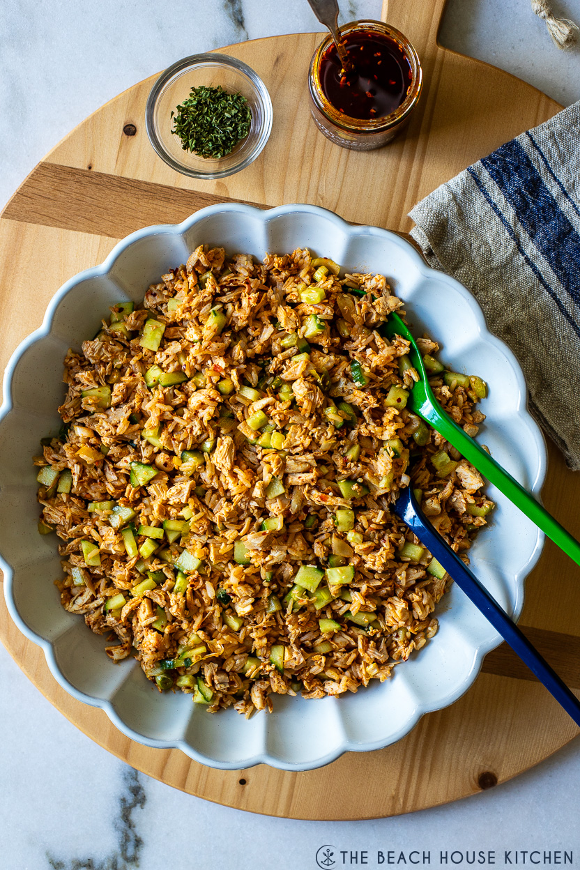 Overhead photo of a platter filled with a spicy chicken and rice salad