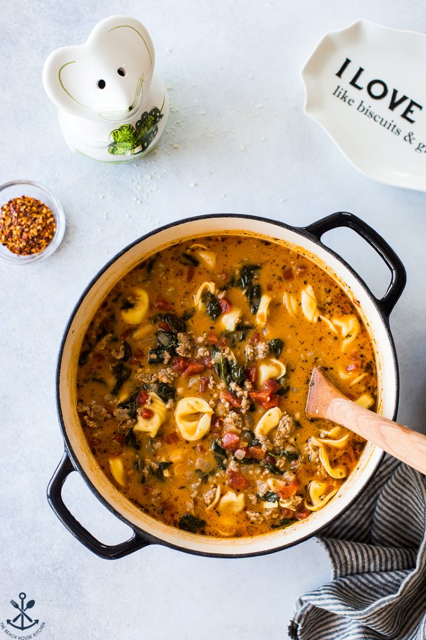 Overhead photo of a pot of tomato tortellini stew