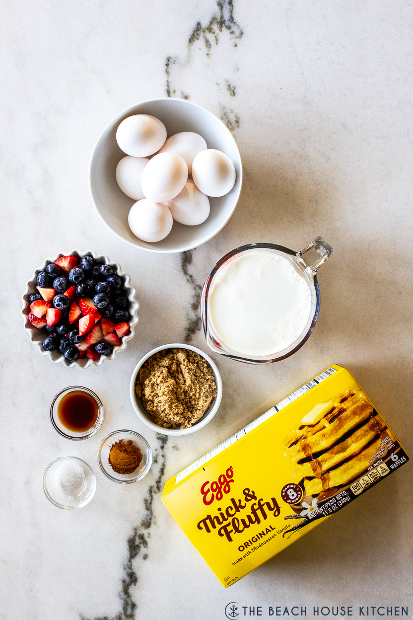 Overhead photo of ingredients for a waffle breakfast casserole with berries