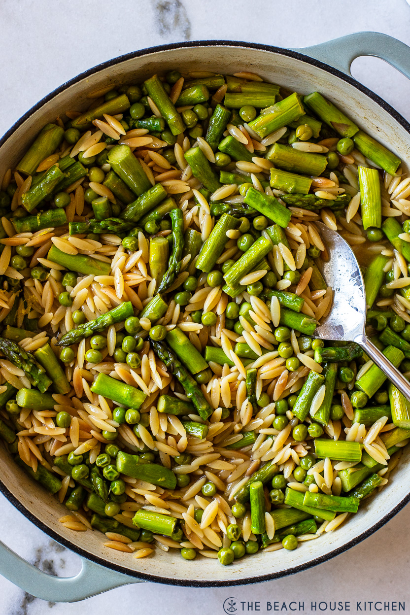 Up close overhead photo of asparagus and pea orzo