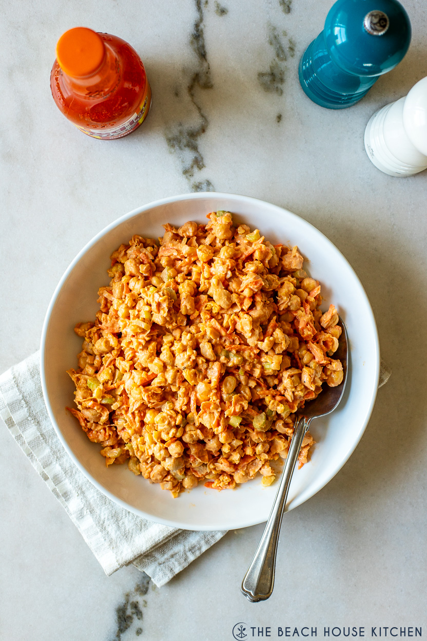 Overhead photo of a white plate filled with buffalo chickpea salad