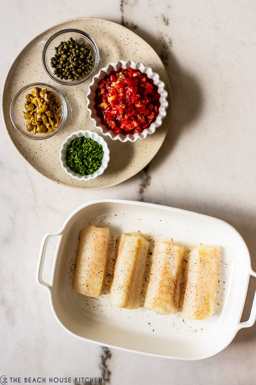 Overhead photo of ingrdients for baked cod with pico de gallo and olives