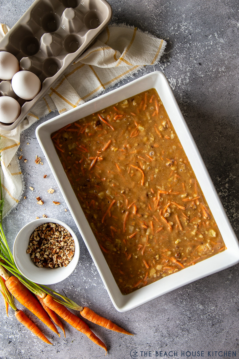 Overhead photo of prebaked carrpt cake in a rectangular white baking dish
