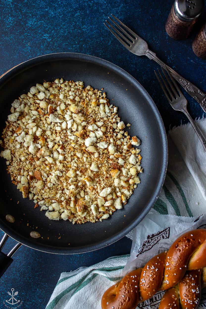Overhead photo of a skillet filled with hot pretzel crumbs
