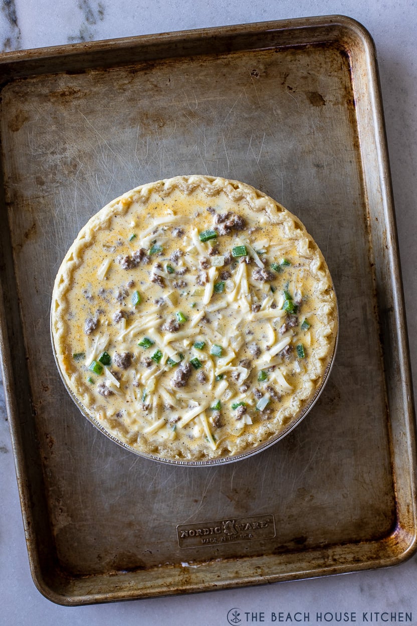 Overhead photo of a prebaked sausage pepper and onion quiche