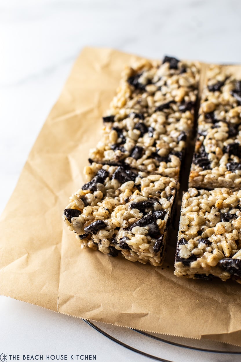 Up close photo og square of Oreo rice krispie treats on a light brown piece of parchment paper