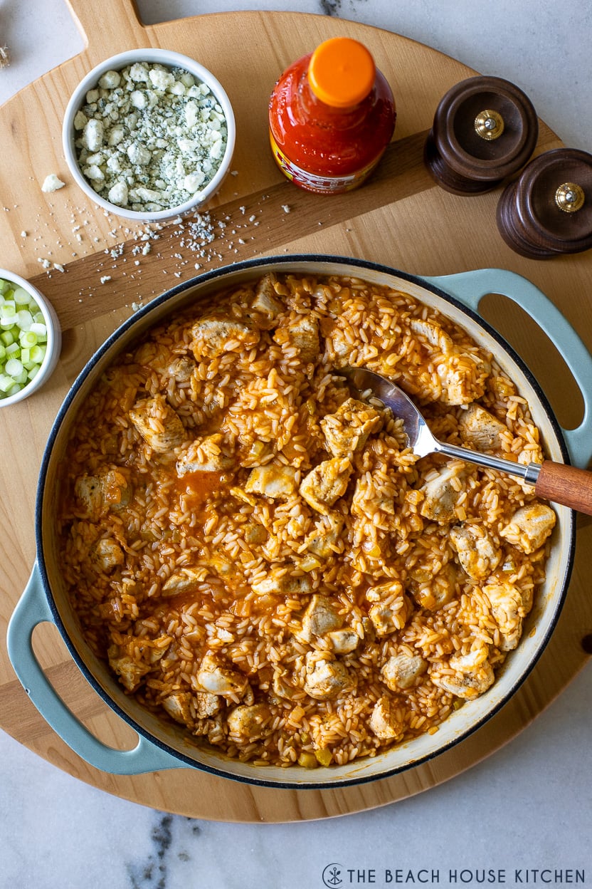 Overhead photo of a round cast iron dish filled with buffalo chicken and rice
