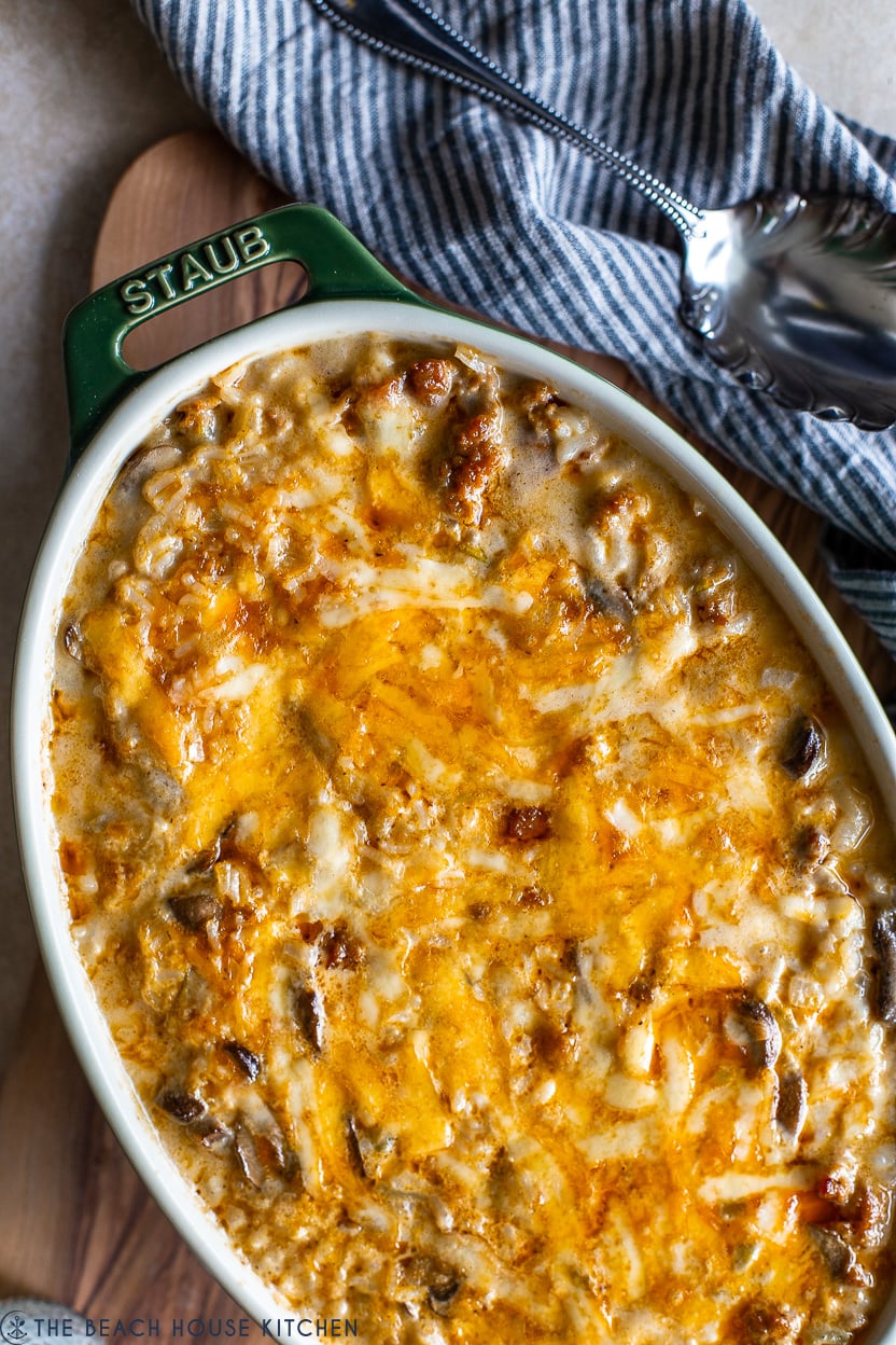 Up close overhead photo of a cheesy rice and sausage dish