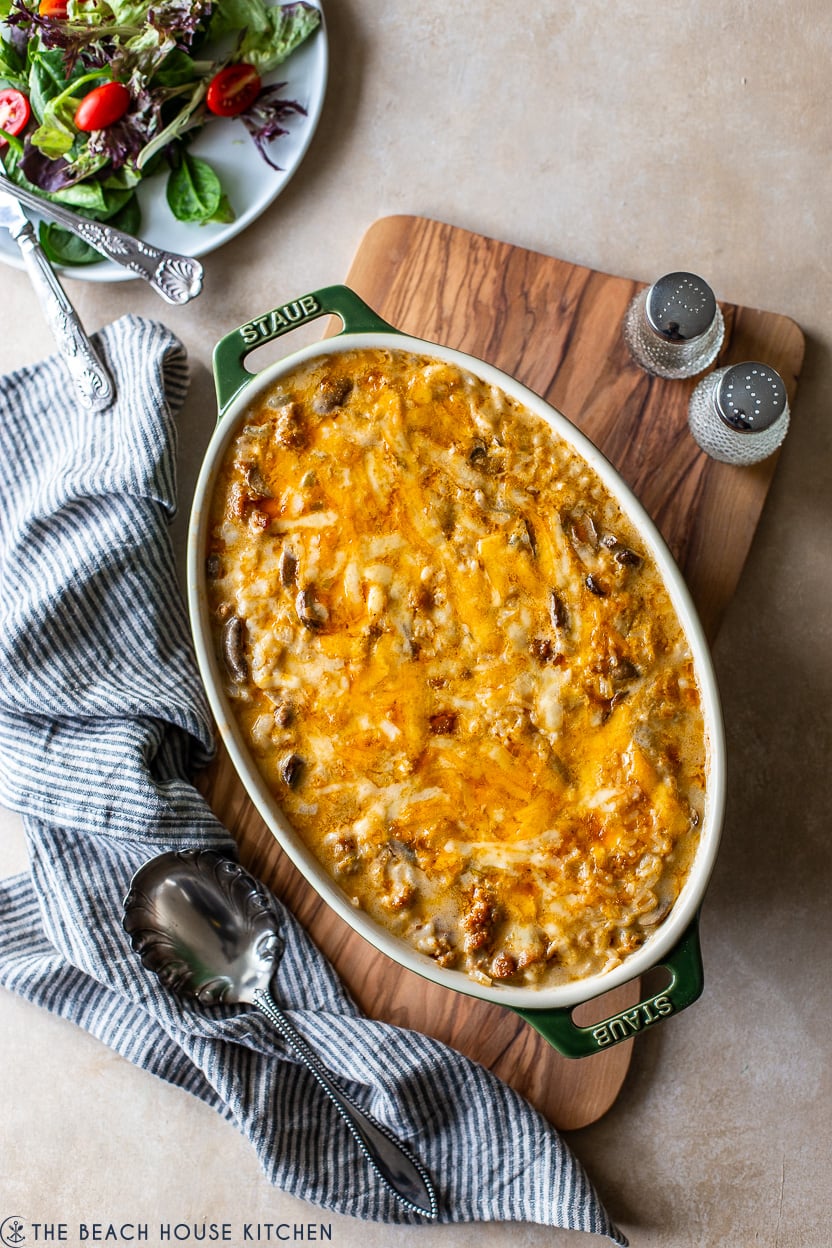 Overhead photo of an oval dish of a cheesy spicy sausage rice bake