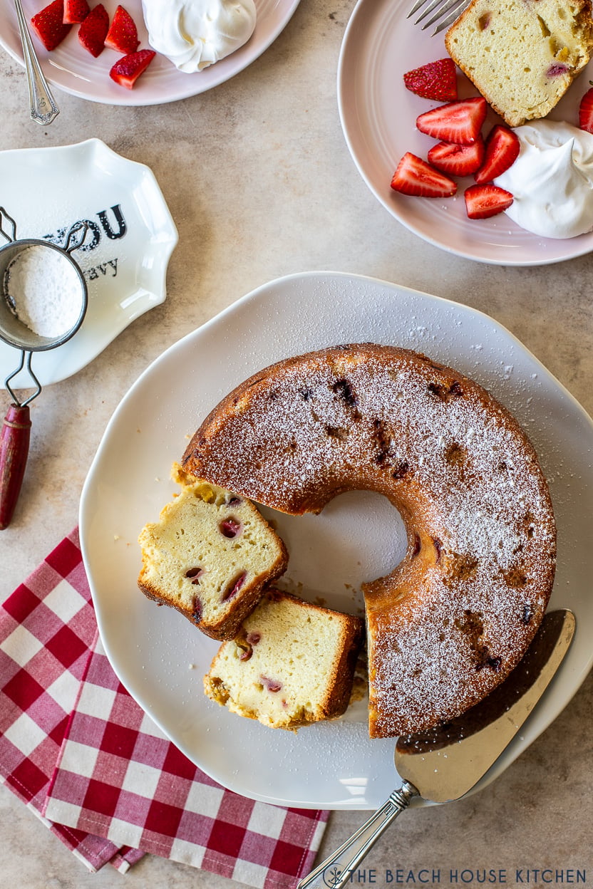 Overhead photo of a strawberry mango pound cake on a white platter