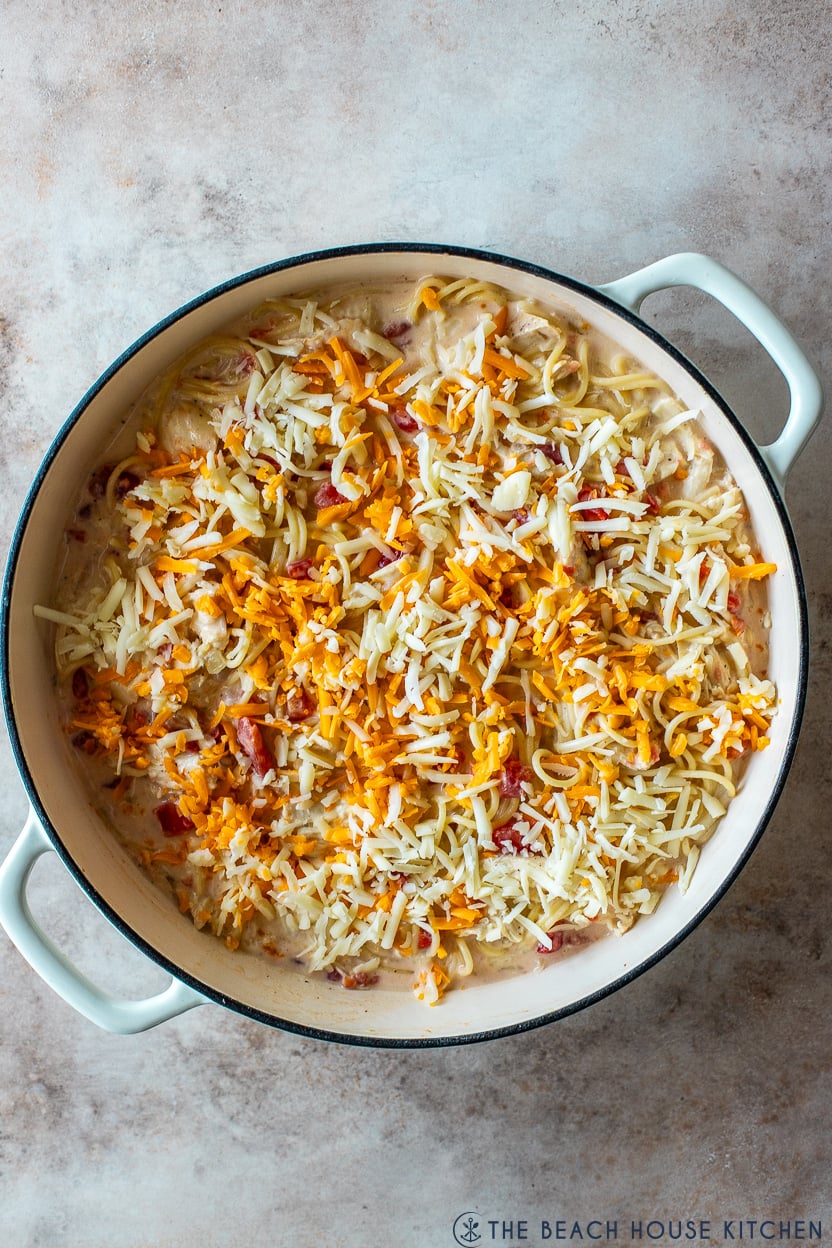 Overhead photo of a pasta dish topped with shredded cheddar cheese