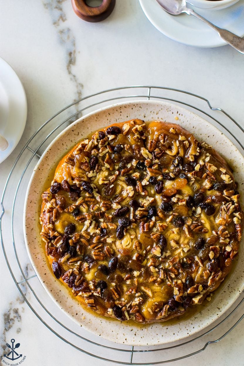 Up close overhead photo of a round dish of pecan raisin sticky buns