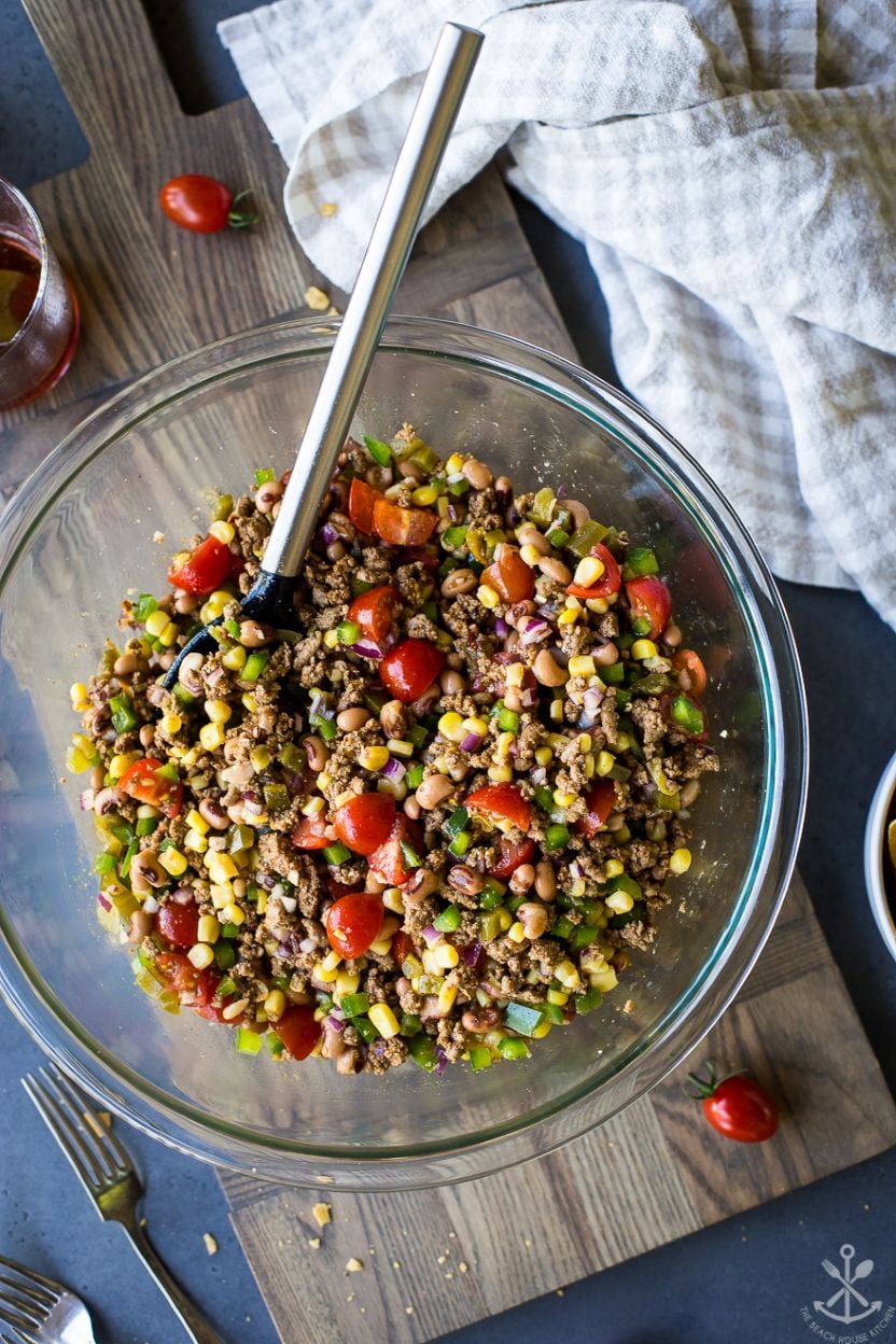 Overhead photo of a glass bowl filled with ground turkey cowboy caviar