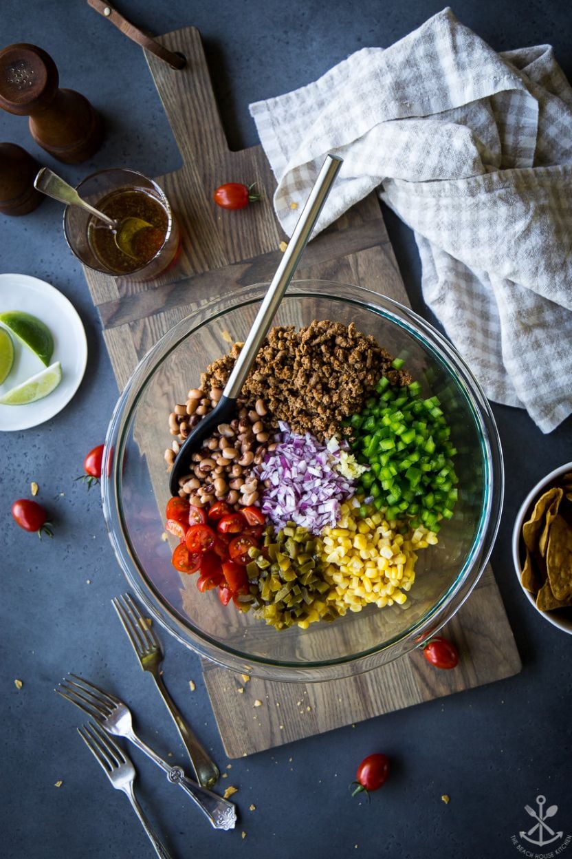 Overhead photo of a glass bowled filled with pre-mixed ground turkey cowboy caviar ingredients