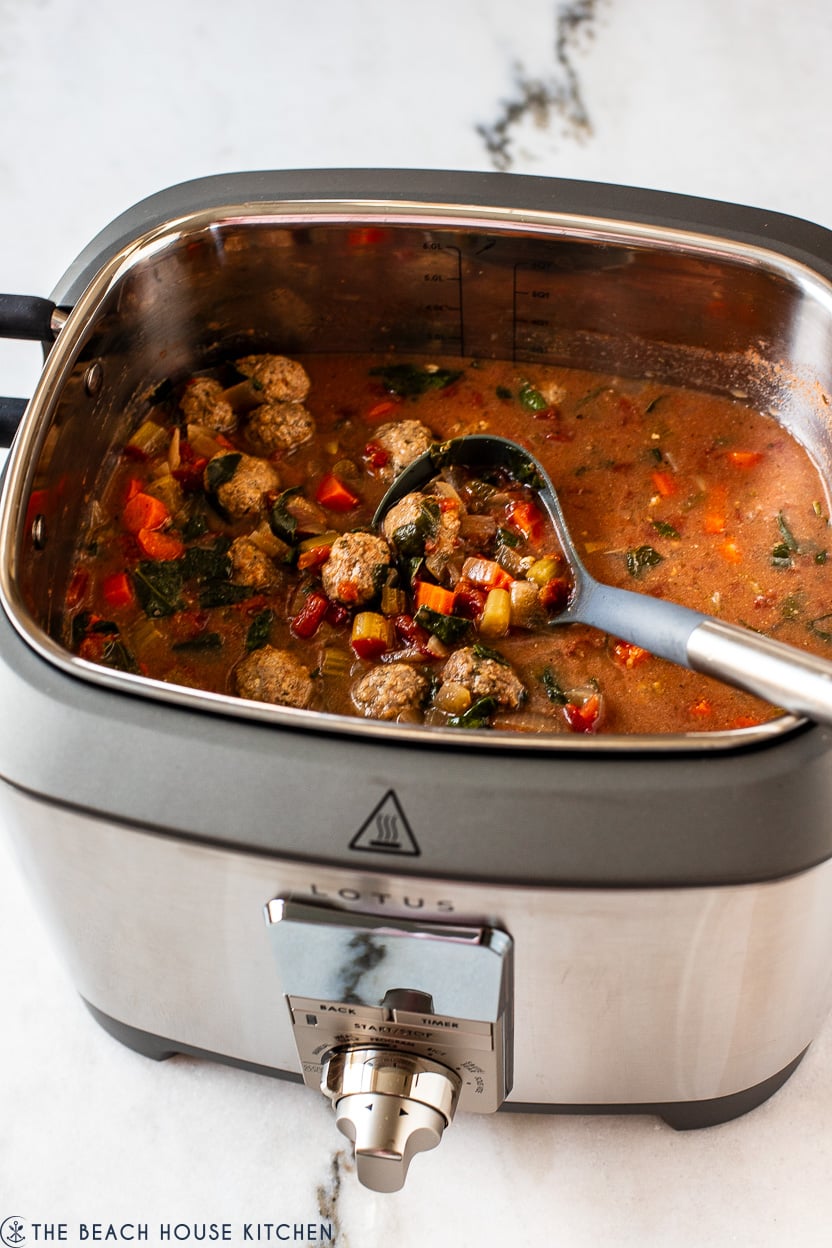 A slow cooker filled with Italian Meatball Soup