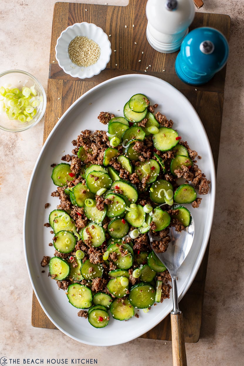 Overhead photo of a white oval platter of Stir-Fried Cucumber and Beef