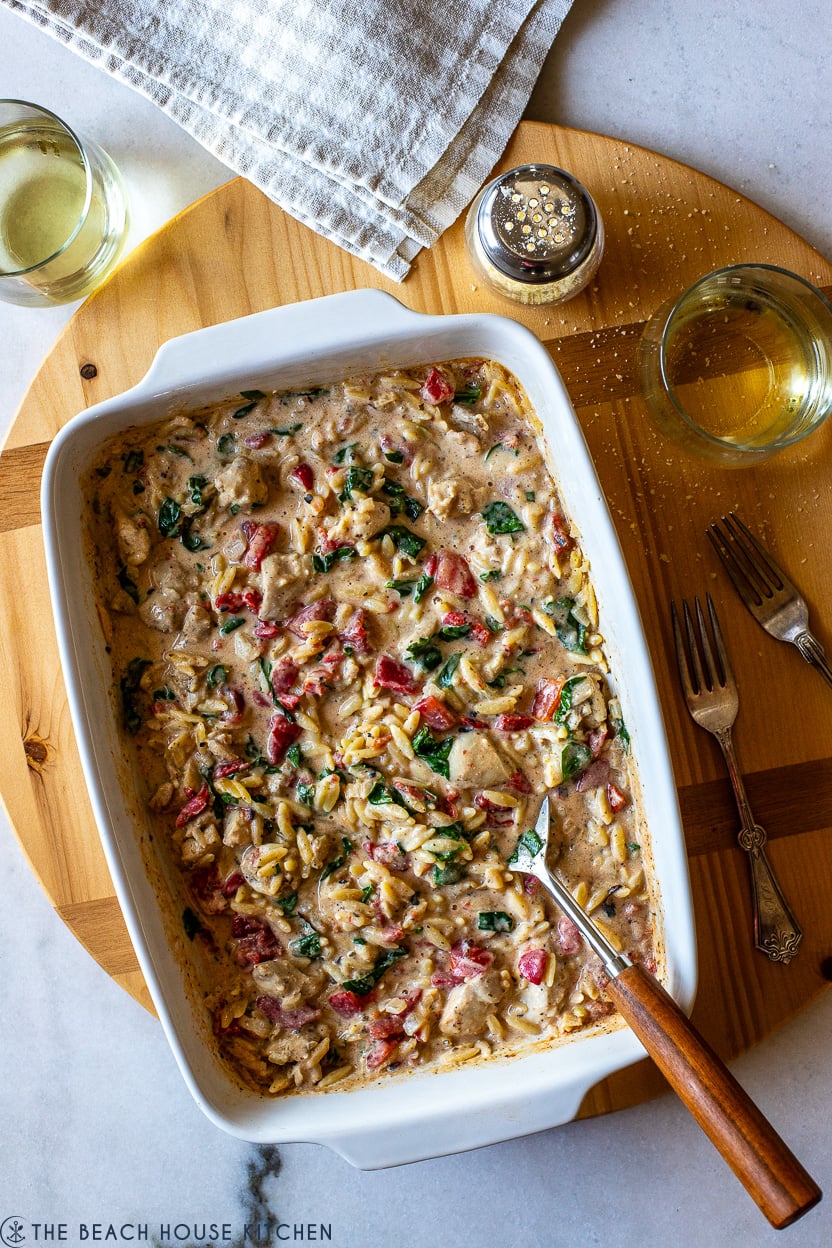 Overhead photo of a white baking dish filled with an orzo chicken dish