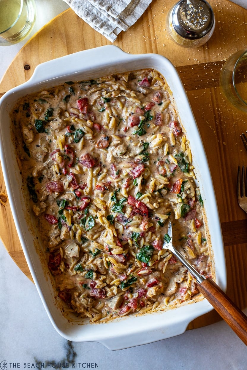 Overhead photo of a cooked cheesy chicken with orzo
