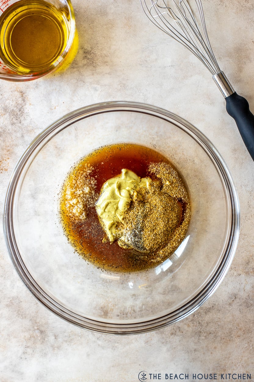 Overhead photo of a bowl of ingredients for a honey dijon marinade