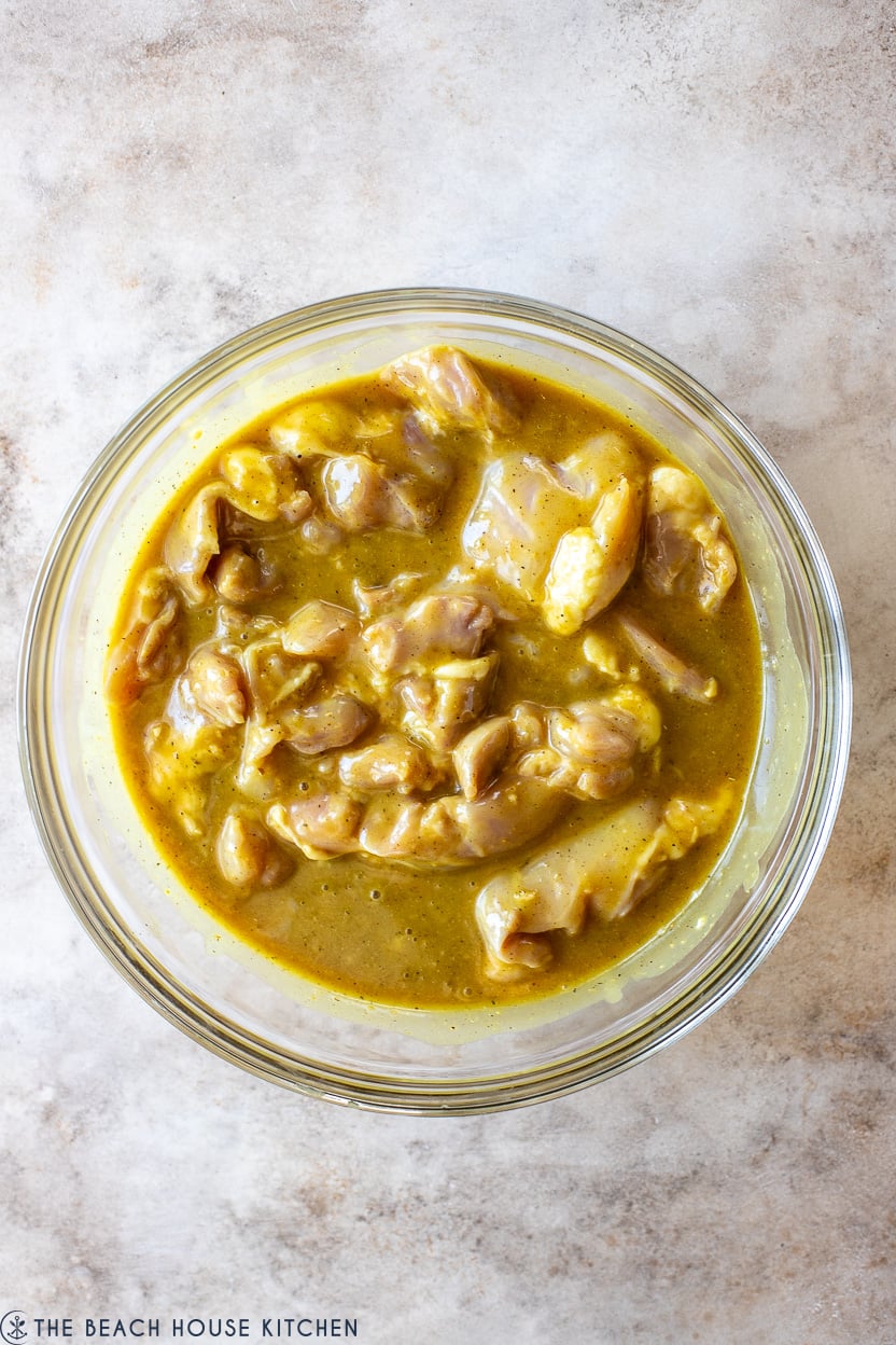 Overhead photo of a bowl of chicken in a honey dijon marinade