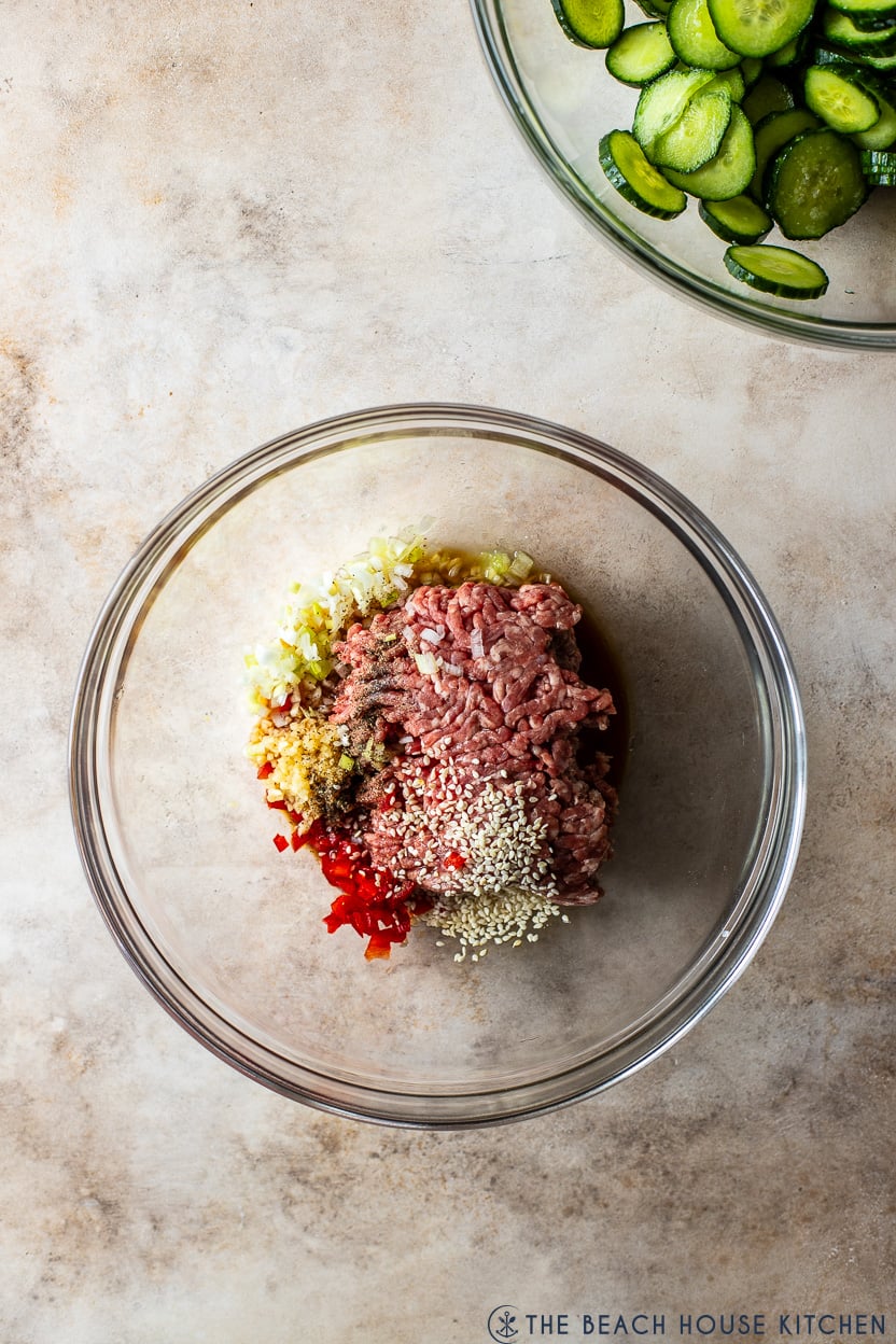 Overhead photo of a glass bowl filled with ground beef and spices