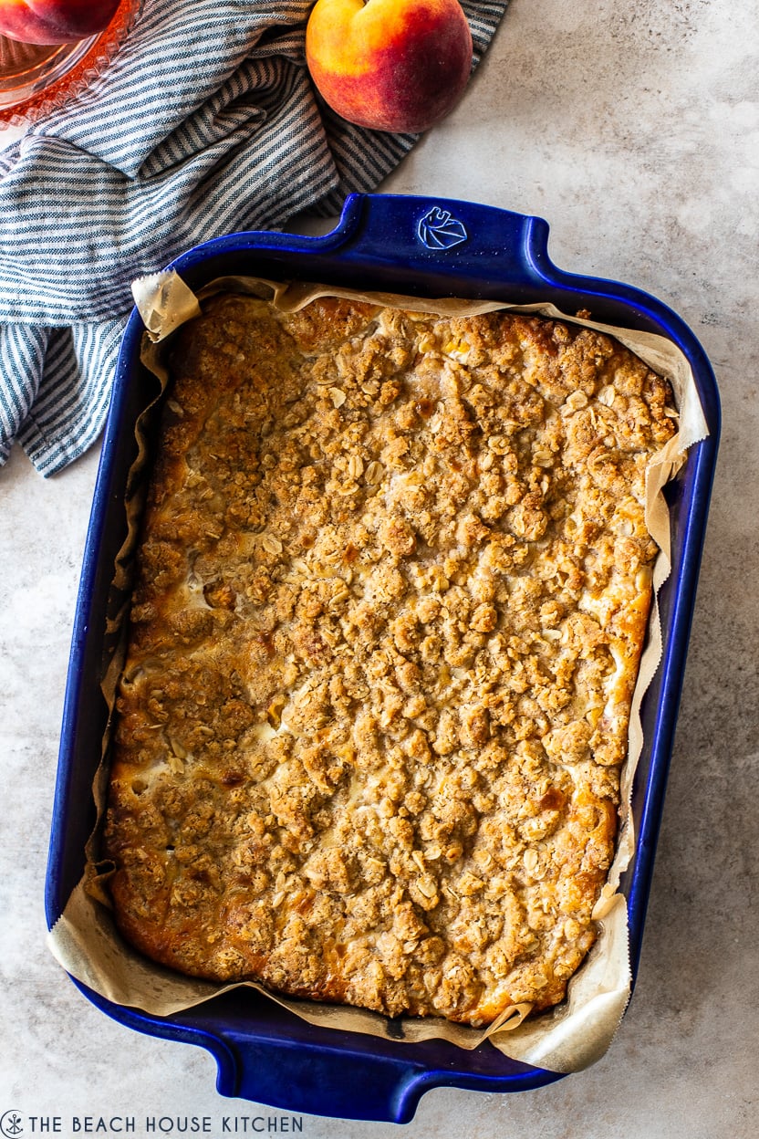 Overhead photo of a blue baking dish filled with peach streusel bars