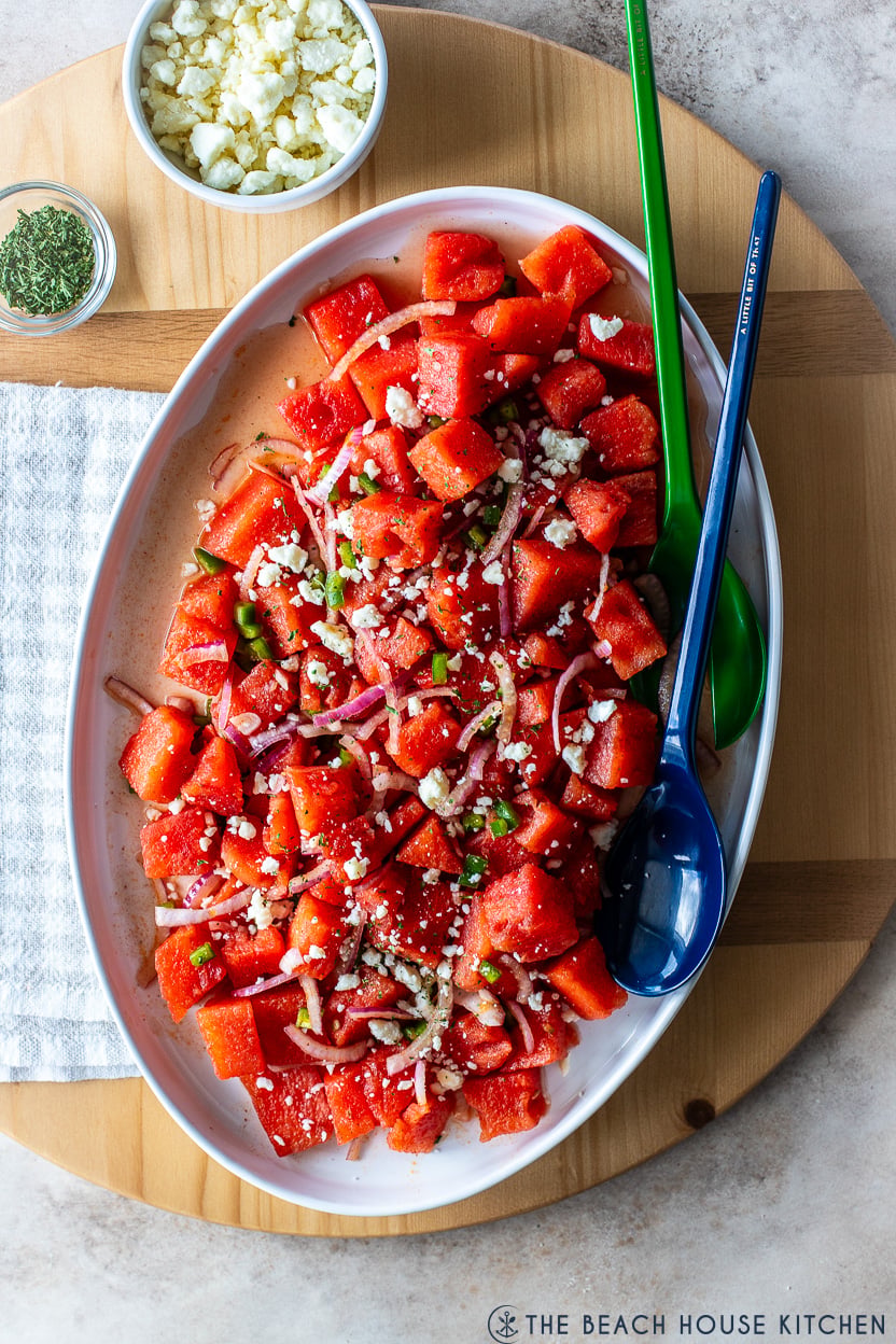 Overhead photo of a watermelon salad on a white platter
