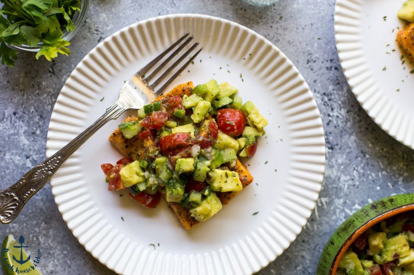 Overhead photo of a piece of salmon toppwed with avocado salsa