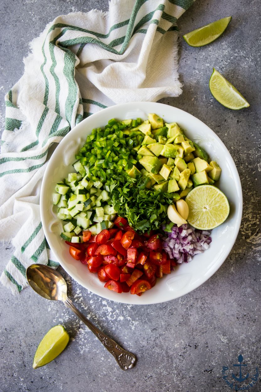 Overhead photo of pre-mixed ingredients for avocado and tomato salsa