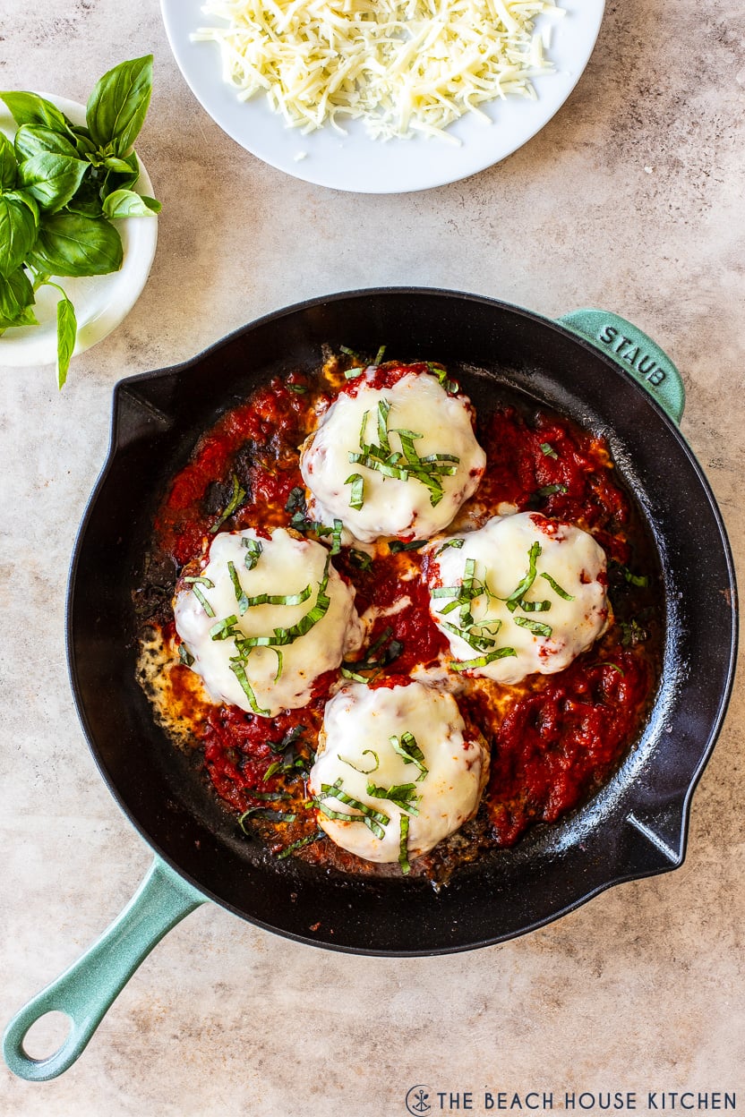 Overhead photo of a skillet of ground chicken pizza burgers