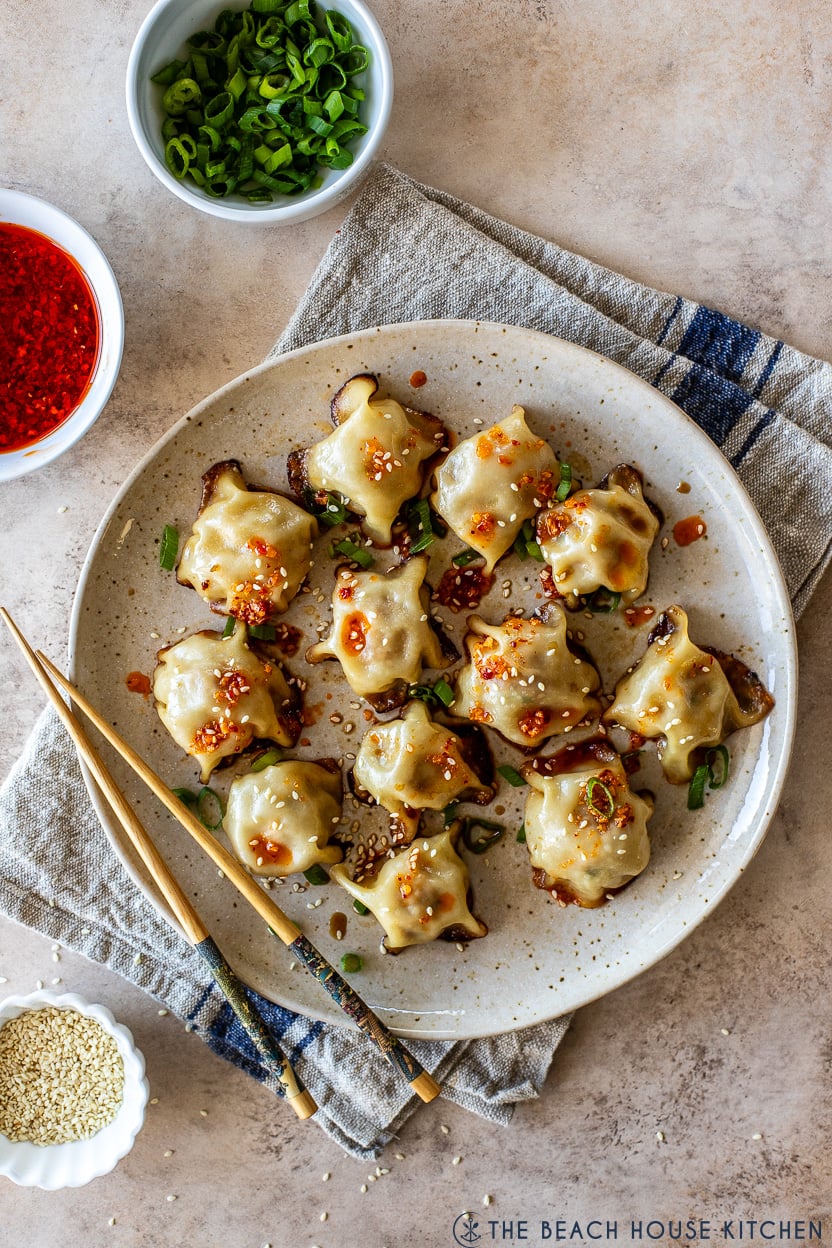 Overhead photo of a plate of viral blanket dumplings on a plate with chopsticks