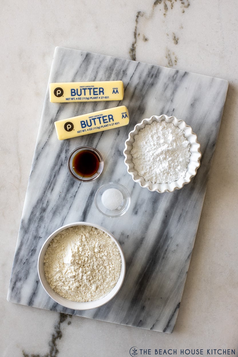 Overhead photo of ingredients for cinnamon roll cookies on a marble board