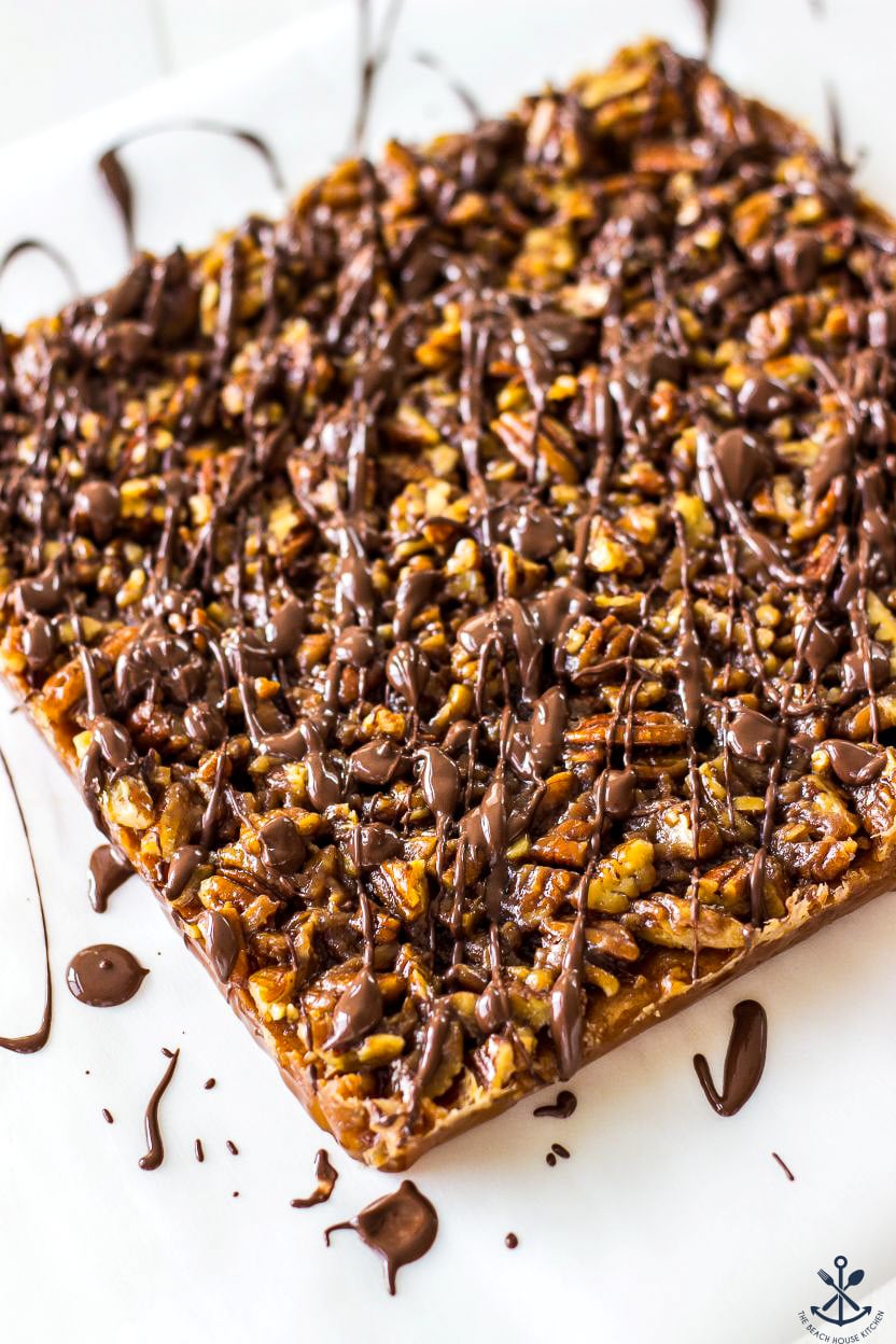 A photo of chocolate drizzled maple pecan bars