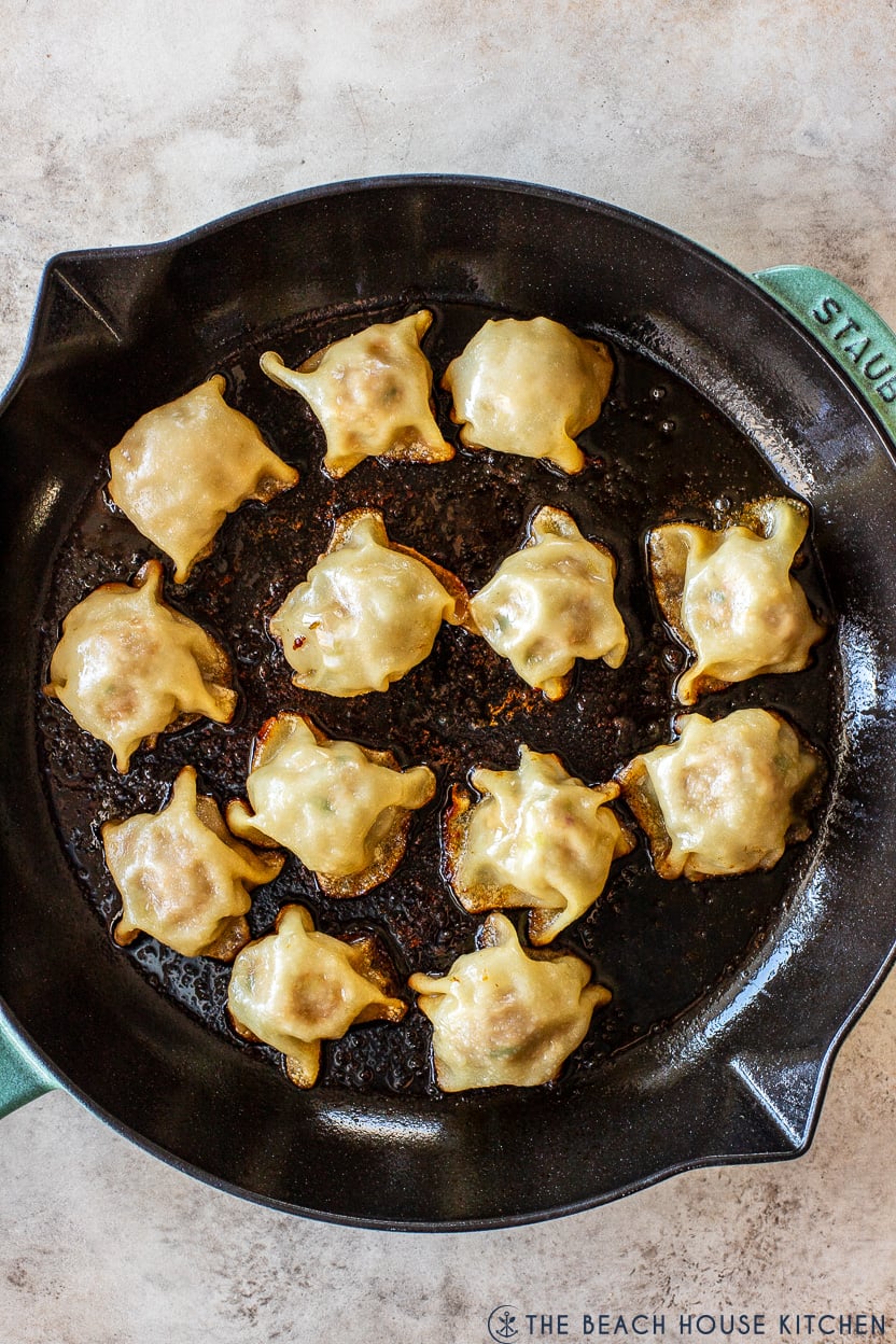 Up close overhead photo of a skillet of viral blanket dumplings